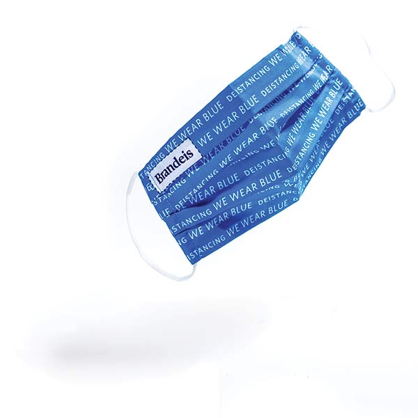 A blue surgical mask emblazoned with the Brandeis logotype.