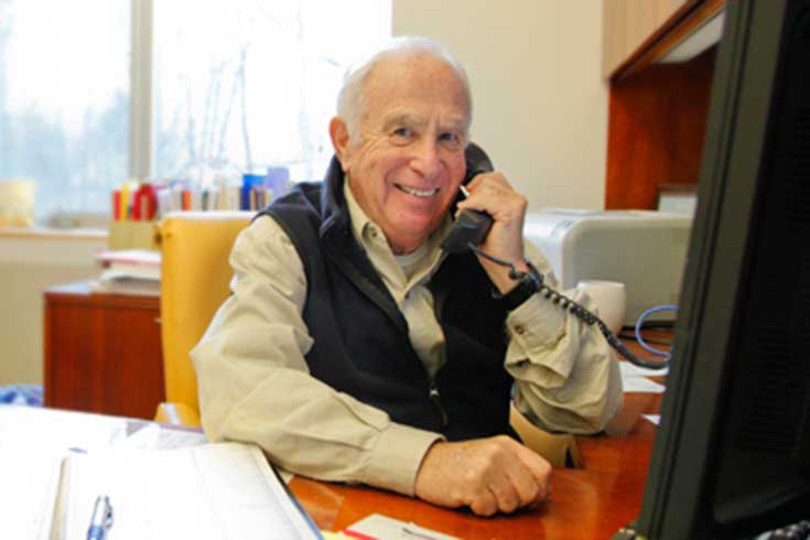 Stuart Altman on the phone at his desk