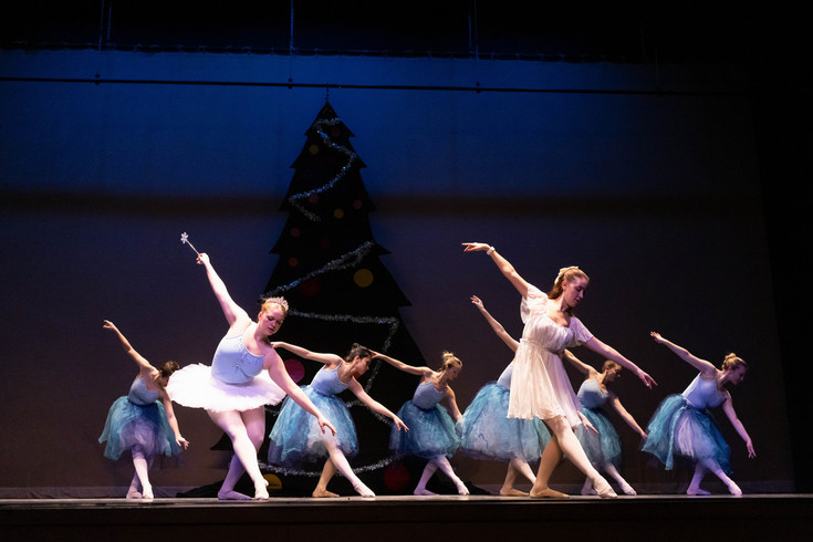 Students performing ballet on stage.