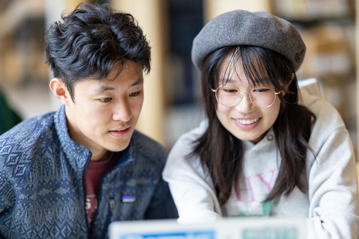 two smiling students having a discussion