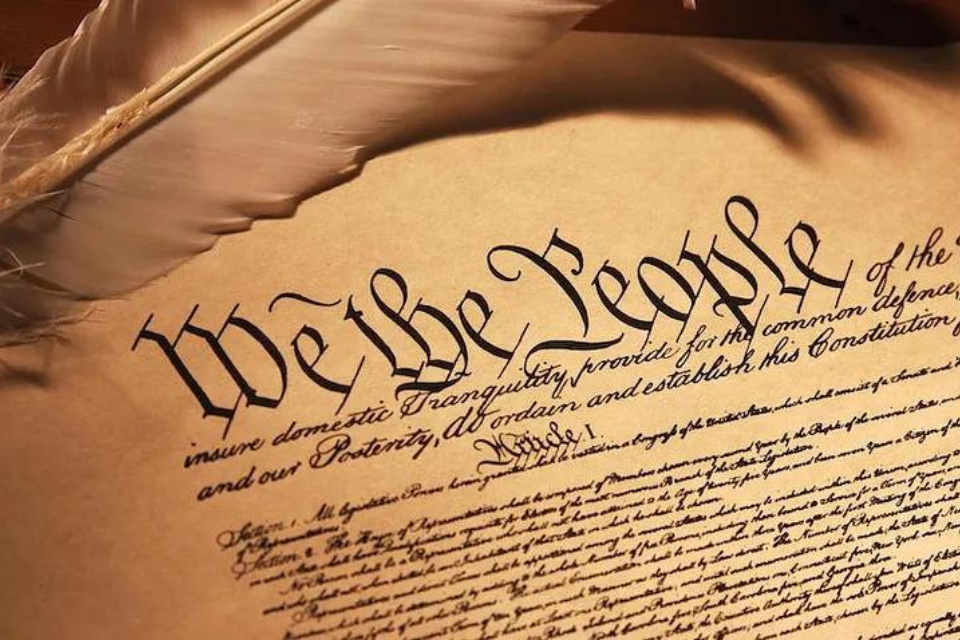 Picture of the U.S. Constitution on yellowed paper, reading "We the People"