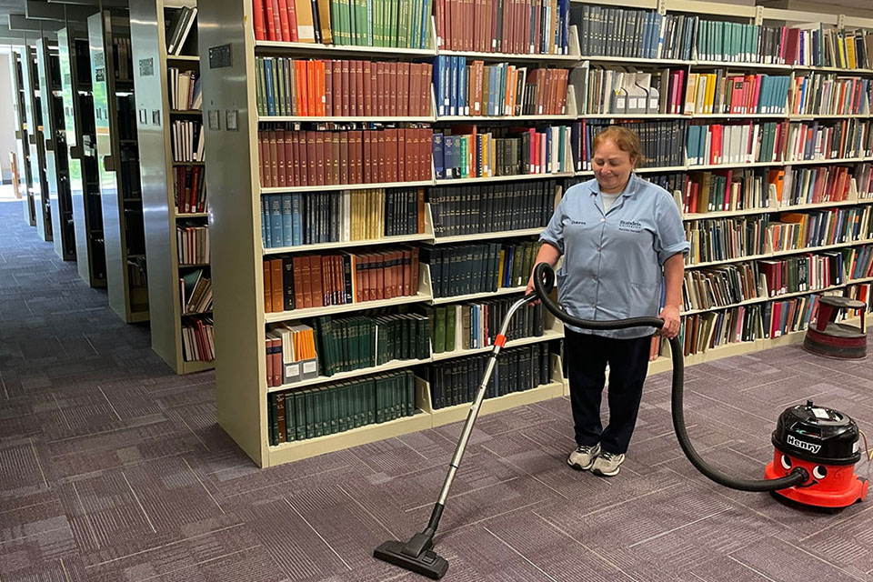 Person vacuuming a rug