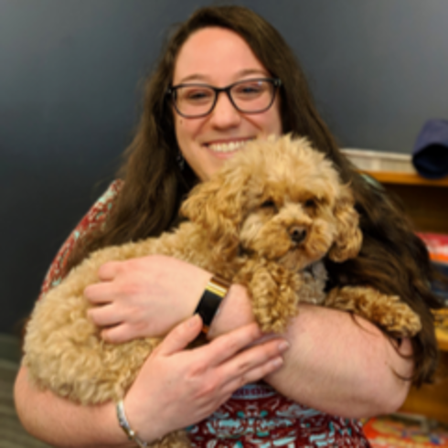 Esther Brandon holding a fluffy dog.