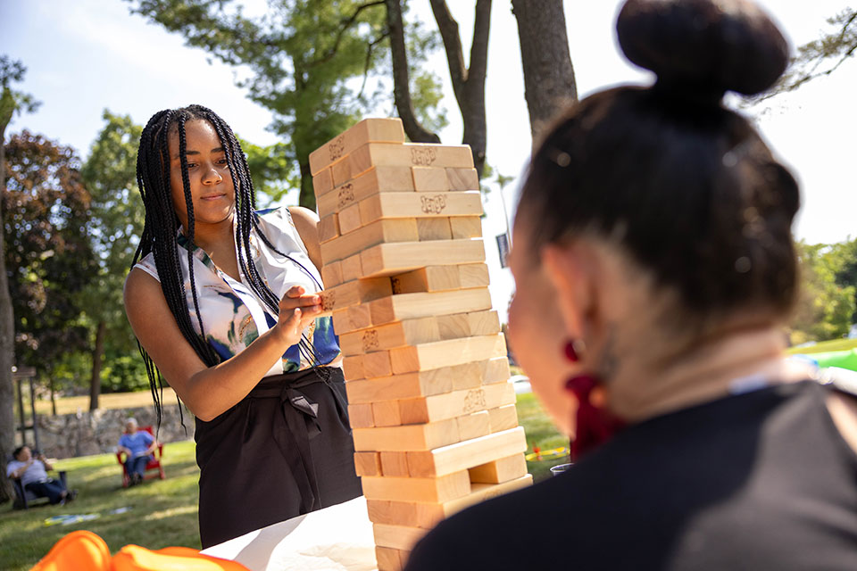 Two staff members play a game of Jenga.