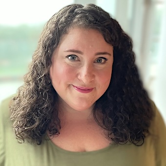 Deborah Rosenstein poses in front of a light background