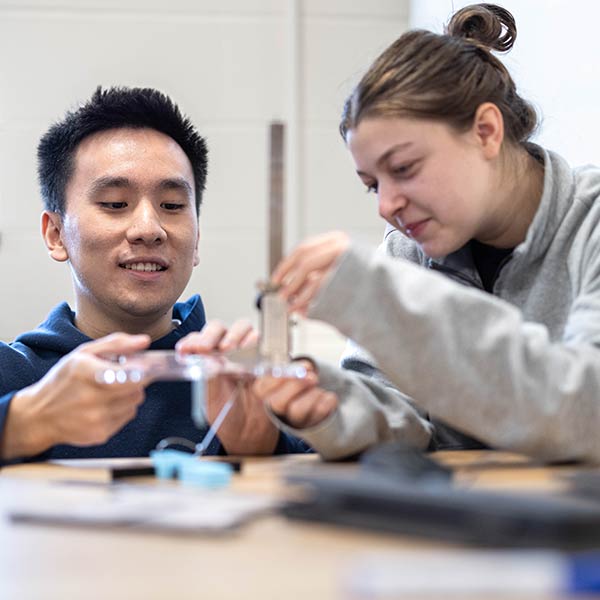 Two engineering students working on a project