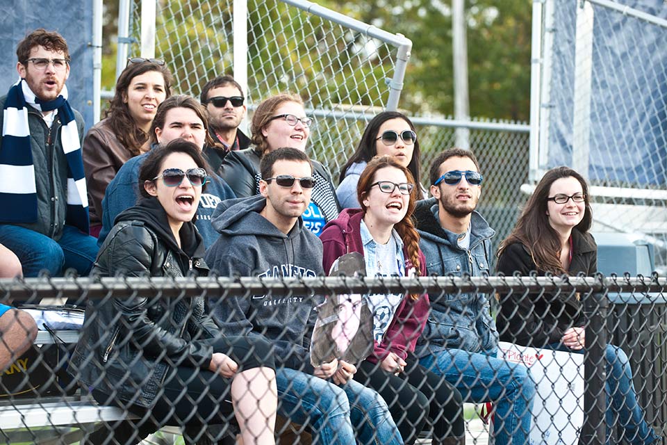 Group of people cheering at homecoming