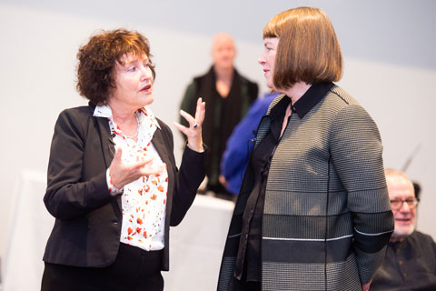 Karnit Flug speaking with Lisa M. Lynch, offstage. 