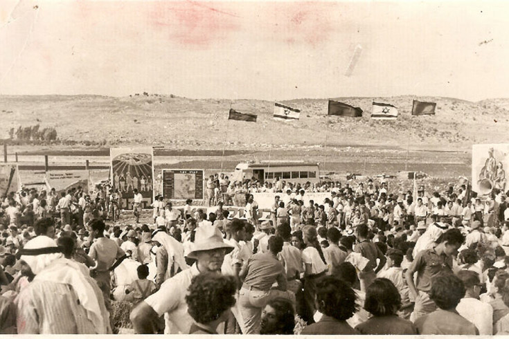 Large crowd of people outside in the desert