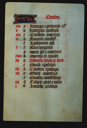 Page 10r with a large illuminated letter and the month (October in Latin). The rest of the page is lettered by hand with a list, each line has a red letter on the left in sequence from a - g (presumably the days of the week), and then it starts again from a. In the left margin are some notes in red corresponding to some of the lines. 