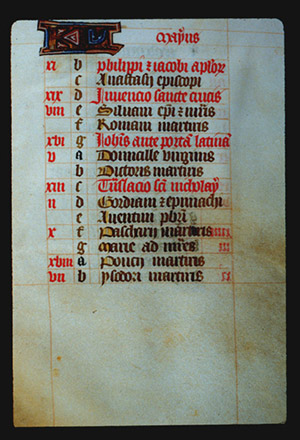 Page 5r with a large illuminated letter and the month (May in Latin). The rest of the page is lettered by hand with a list, each line has a red letter on the left in sequence from a - g (presumably the days of the week), and then it starts again from a. In the left margin are some notes in red corresponding to some of the lines. 