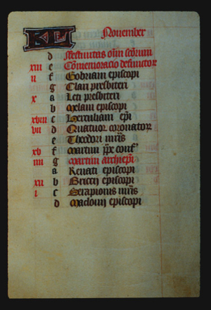 Page 11r with a large illuminated letter and the month (November in Latin). The rest of the page is lettered by hand with a list, each line has a red letter on the left in sequence from a - g (presumably the days of the week), and then it starts again from a. In the left margin are some notes in red corresponding to some of the lines. 