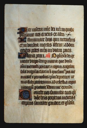 Page 38v, containing a dense block of blackletter text, with one illuminated initial letter.  There are also red inked words, yellow counterspaces and an ornament.