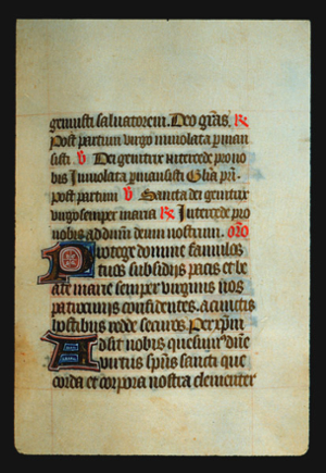 Page 51r, containing a dense block of blackletter text, with 2 illuminated initial letters and several red inked words and yellow counterspaces. 