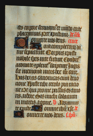 Page 69v, containing a dense block of blackletter text, with 4  illuminated initial letters, 5 red words, and numerous gold counterspaces.