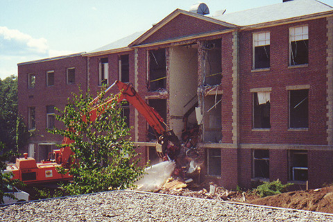 The excavator removes seats from Seifer Auditorium along with other debris.