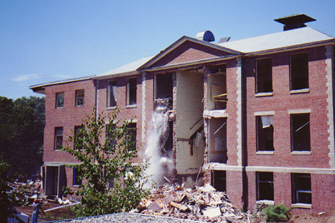 A skid-steer loader pushed debris out of the building. It can be seen in the upper left window of the center bay of Ford Hall.
