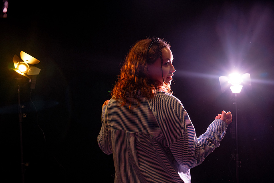 Student illuminated with contrasting lights