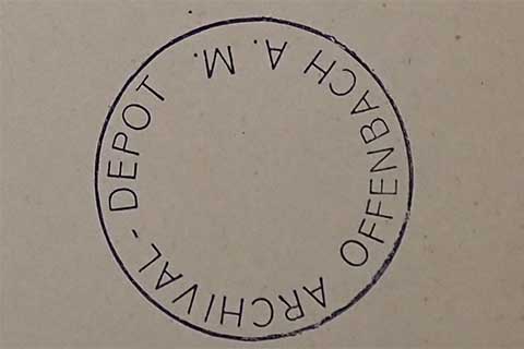 Close-up of a round Offenbach stamp.