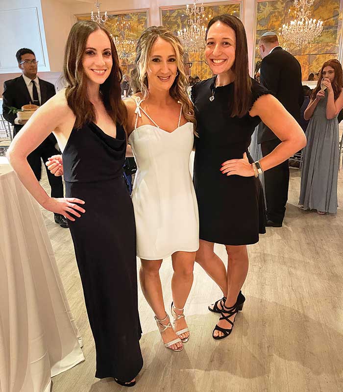 Meryl Kahan stands with two friends at her wedding.