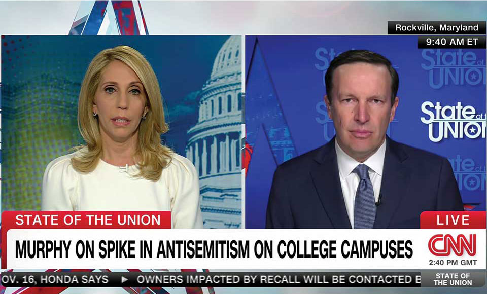 Screen shot of CNN, with a reporter on the left side and Senator Chris Murphy on the right