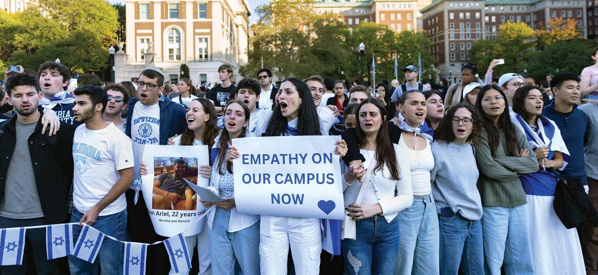 Pro-Israel demonstrators at a Columbia University, one holds a sign that says EMPATHY ON OUR CAMPUS NOW