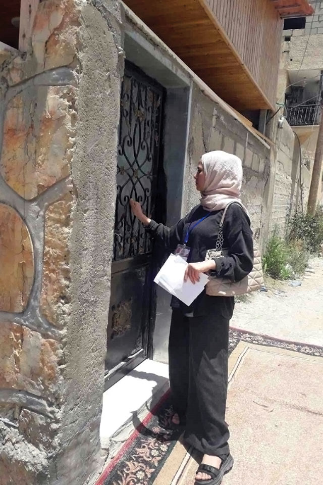 A data collector knocks on doors in the West Bank in 2023.