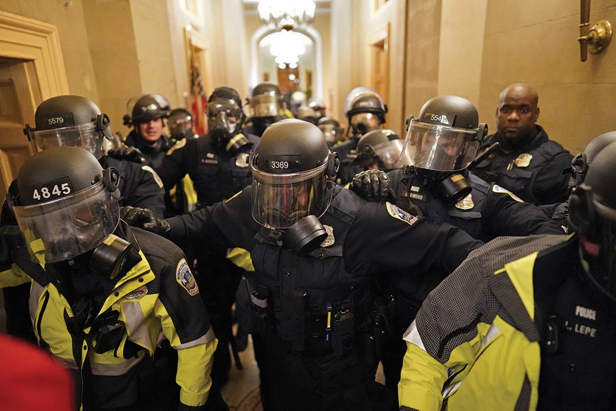Police in riot gear inside the US Capitol