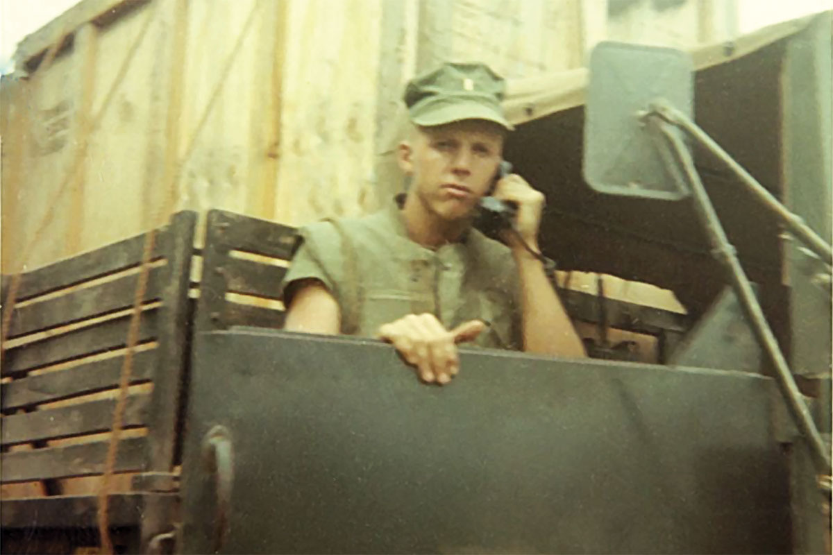 Hammett on the phone in a truck in Vietnam