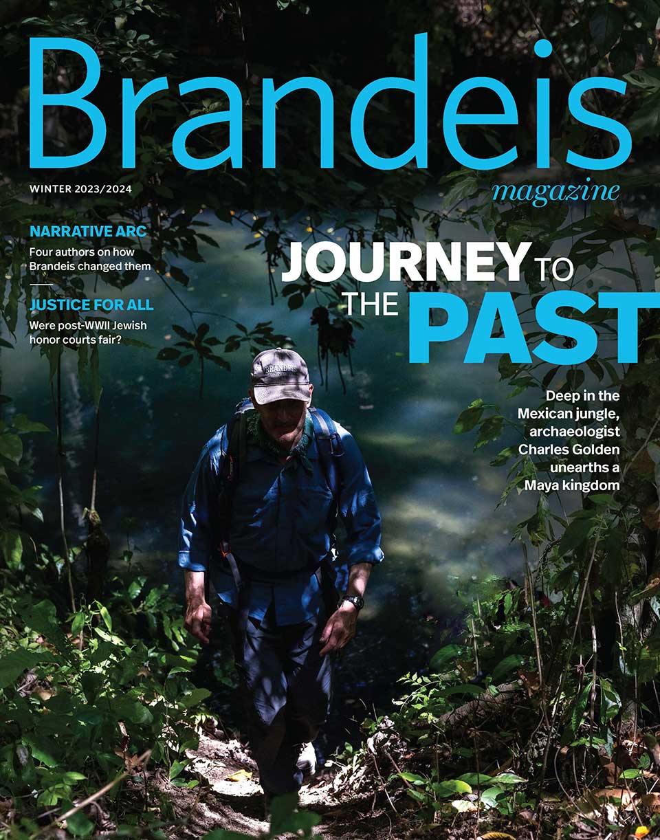 Winter 2023/2024 Brandeis Magazine cover with an image of a person walking in a jungle and text that reads Journey to the Past