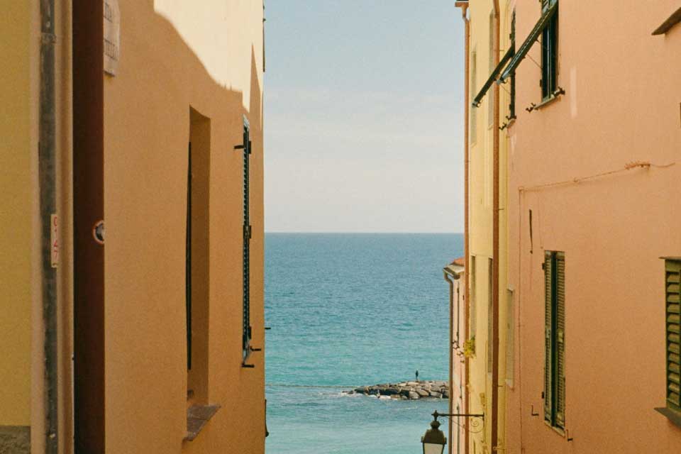 Ocean view between two sand colored buildings