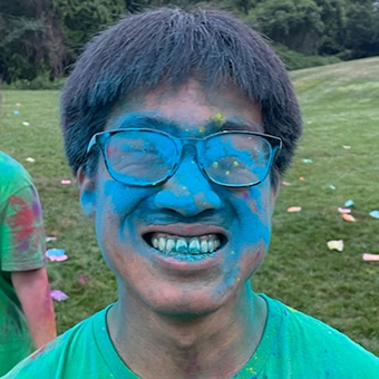 Photo of Wesley Wei covered in blue powder