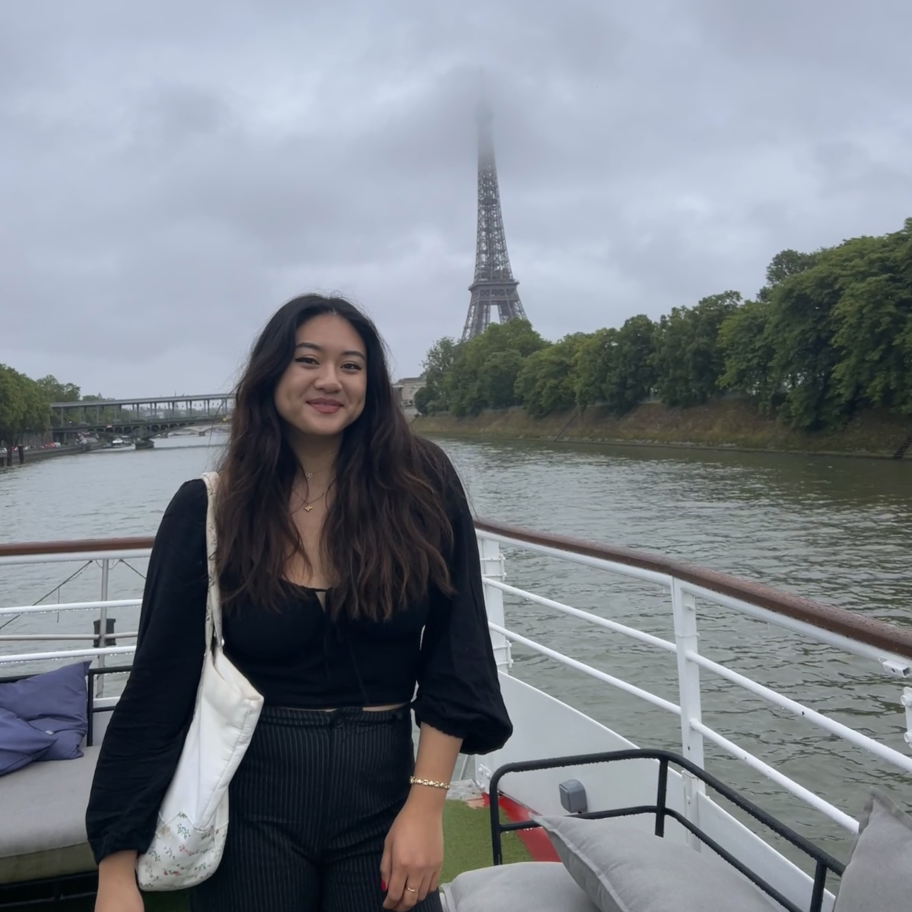 Photo of person in front of Eiffel Tower.