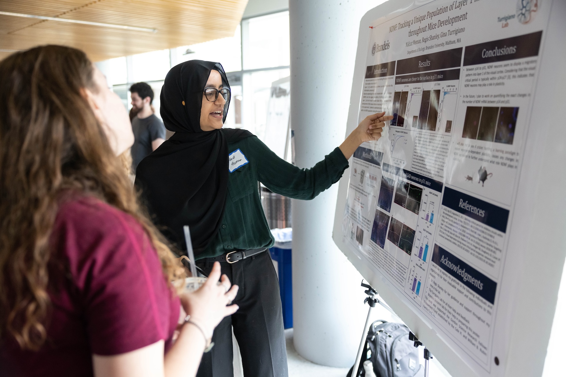 Nikhat Meman presents at a poster session