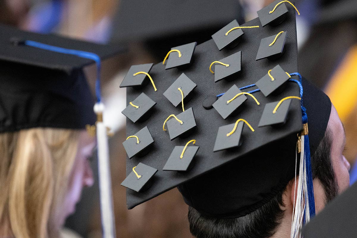 A mortarboard decorated with lots of small graduation caps.