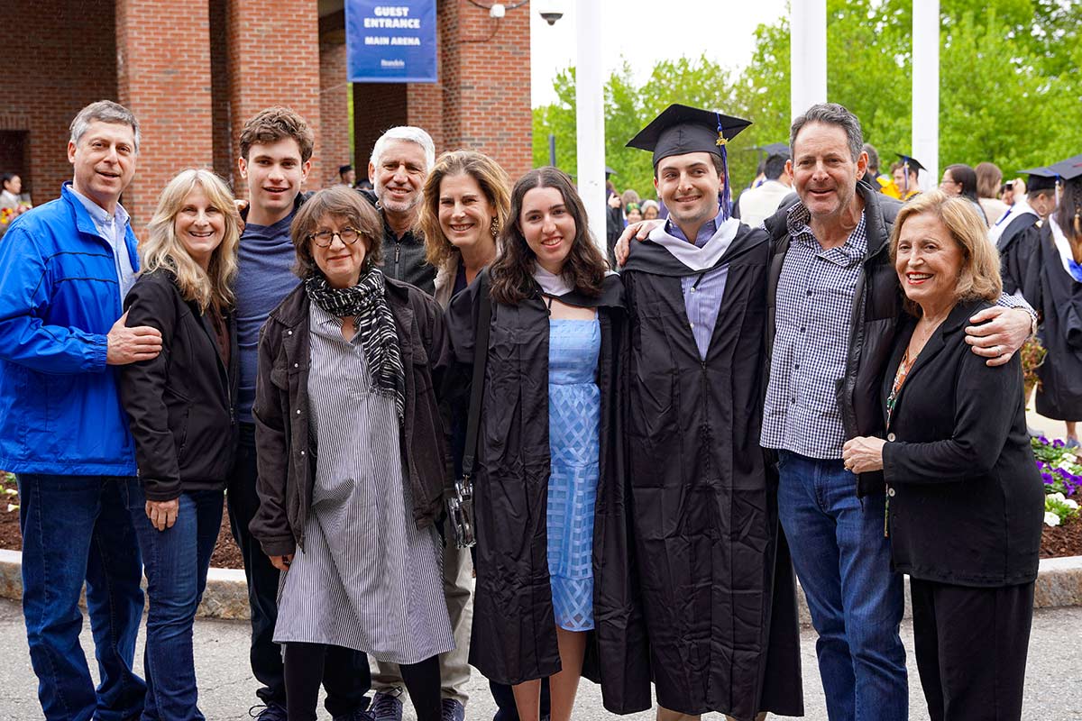 Ten members of a family with two graduates smile