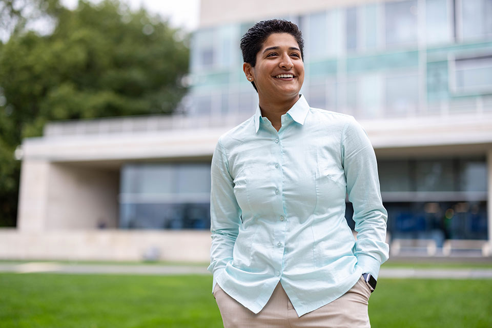 Rani smiling on the Great Lawn in front of the Shapiro Campus Center