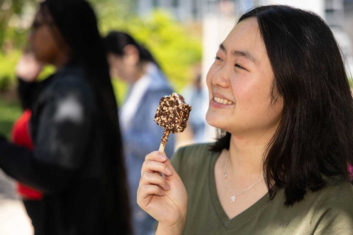 A student enjoys an ice cream cone