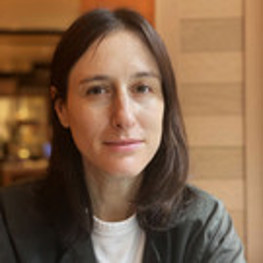 Headshot of Noa Tsaushu in front of a wooden background