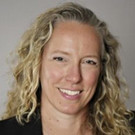 Headshot of Rebecca Wittmann in front of a grey background